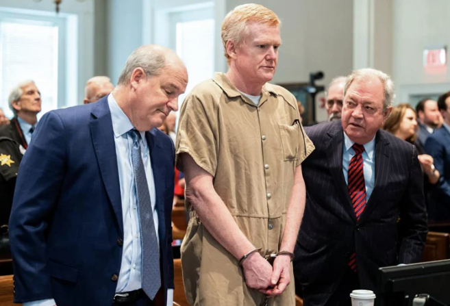 Alex Murdaugh standing in courtroom with lawyers after conviction was overturned