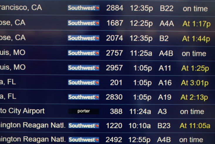 Southwest Airlines flight information board with numerous delayed and cancelled flights