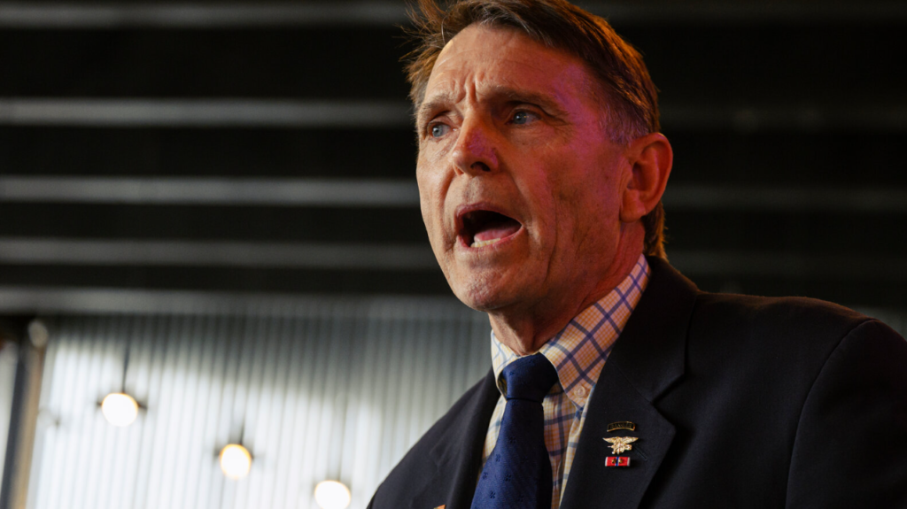 Ed Gallrein speaking at podium during campaign