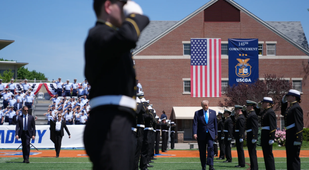 President Trump walking with Coast Guard cadets during commencement ceremony