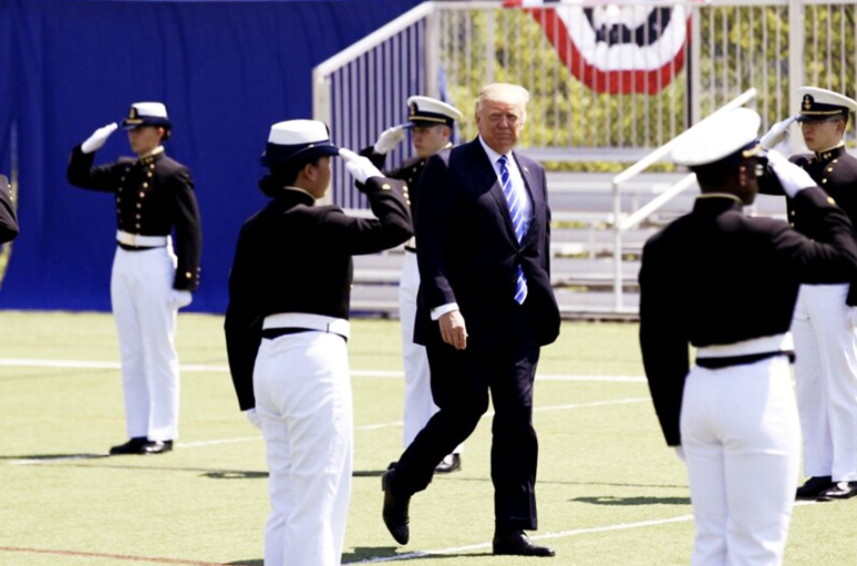 President Trump reviewing Coast Guard Academy graduates in uniform