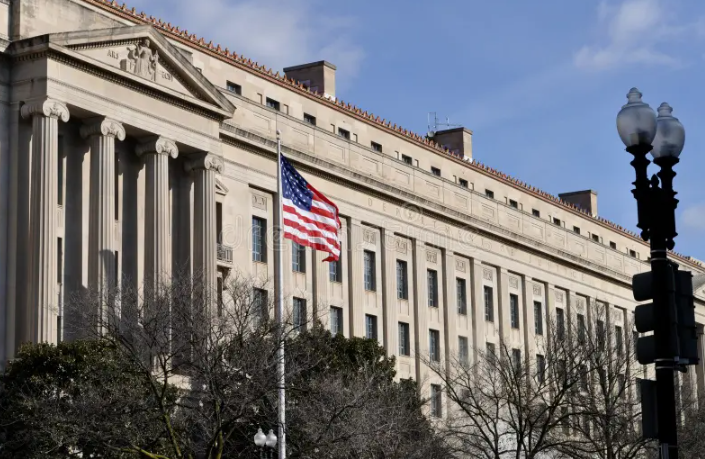 Justice Department building exterior with American flag in Washington DC