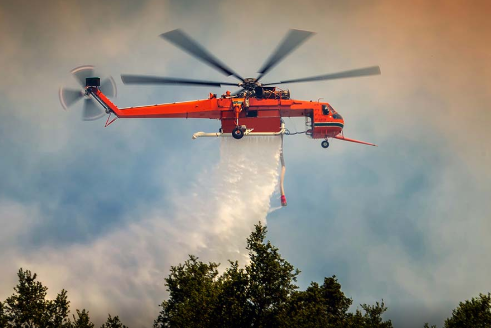 red-helicopter-puts-out-fire